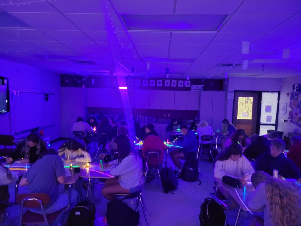 Students in Black Light Lesson working at desks