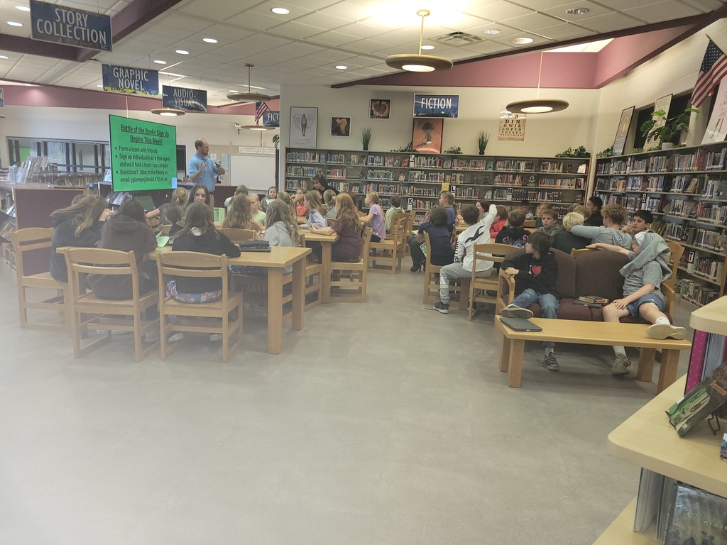 A teacher presenting to library of students.