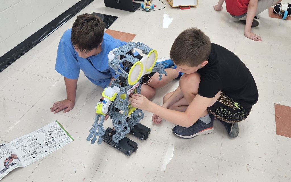 Two students working on a robot.