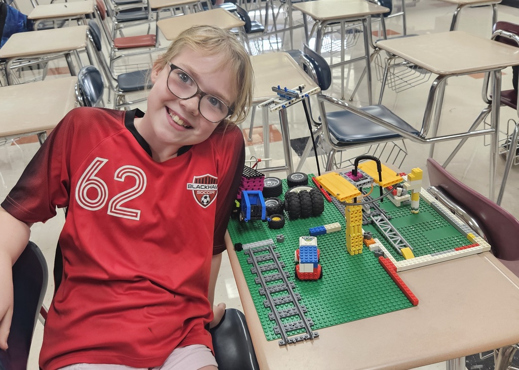 Student smiling with legos.