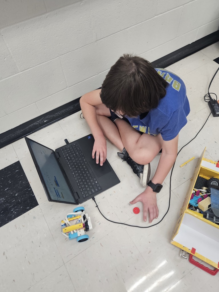 Student working with computer and legos