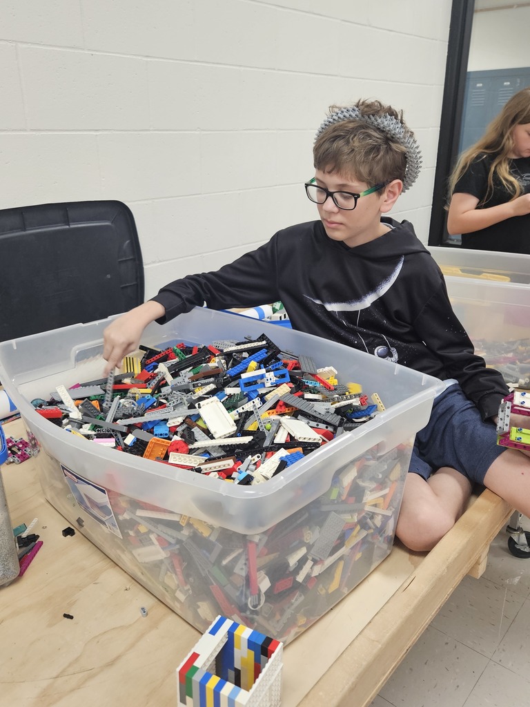 Student with a large box of legos