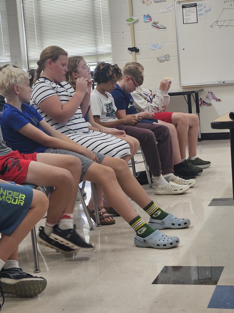 Students looking at items during the speech.