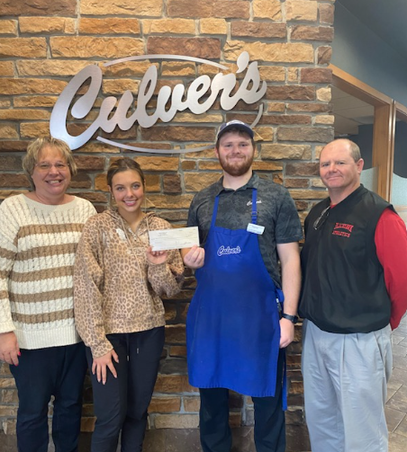 Pictured (left to right): B-W FFA Advisor Michelle Kamm, B-W FFA President Makayla Weyer, Manager Tom Mueller, and B-W High School Principal J.R. Dachel.