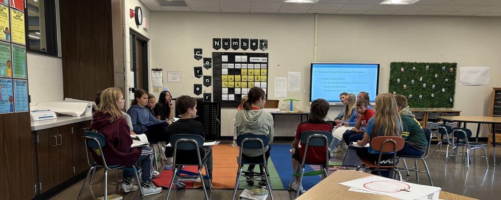 Students in a circle discussing reading.