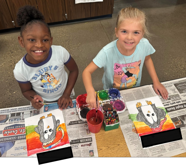 Two students with their penguin art work.