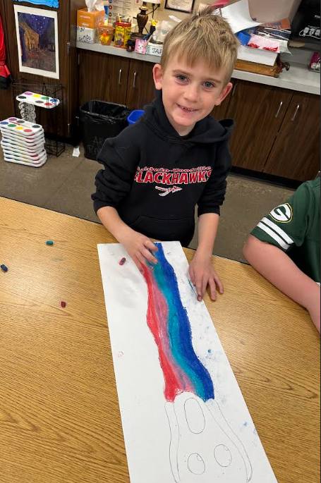 Student smiling with his project