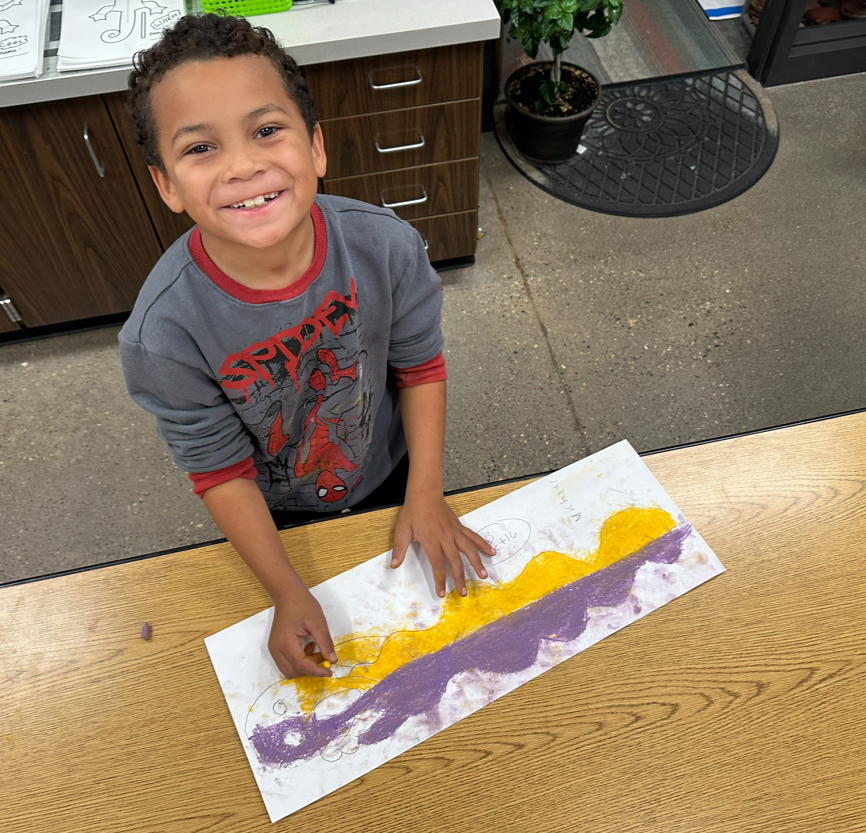 Student smiling with project