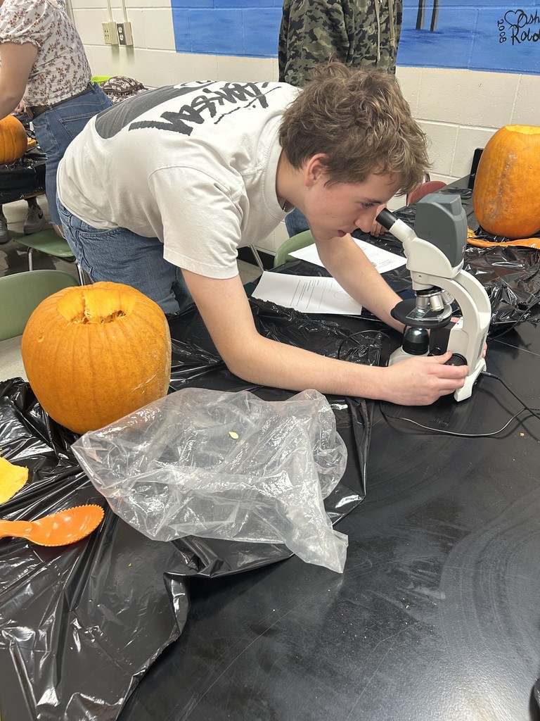 Student looking at microscope.