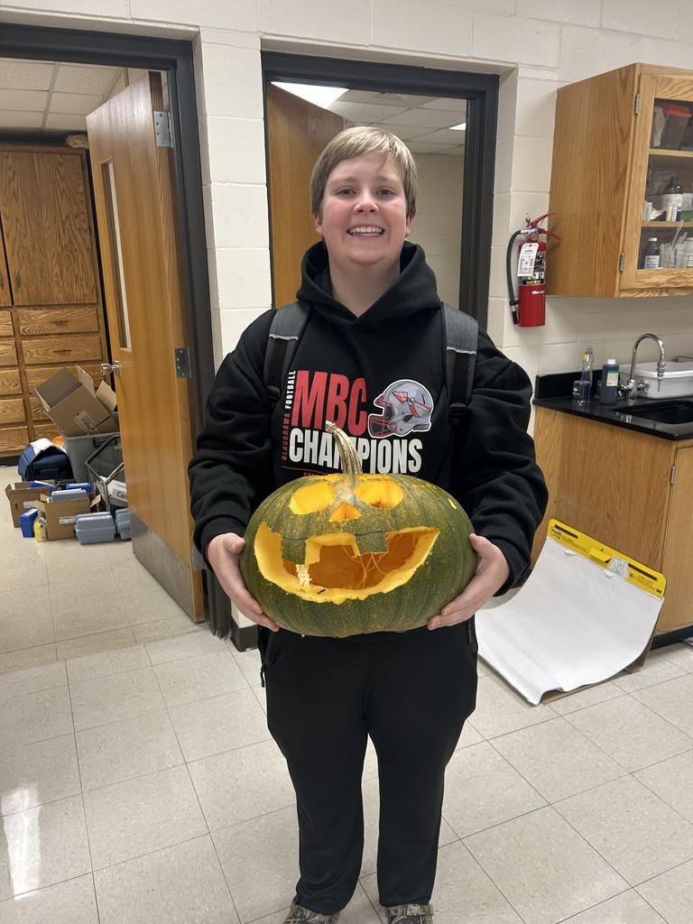 Smiling student with their pumpkin