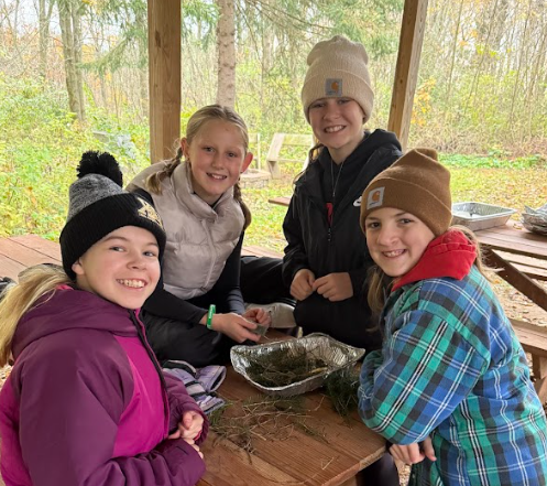 Students smiling at school forest.
