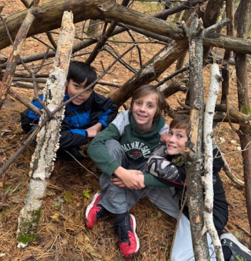 Students in a shelter they built.