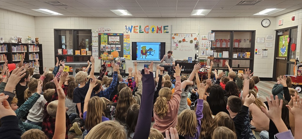 Author with a library full of students.