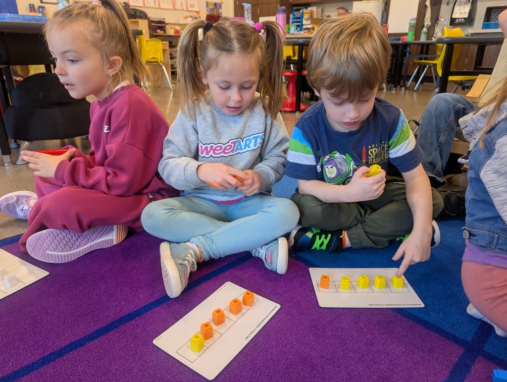 Multiple students talking about math facts.