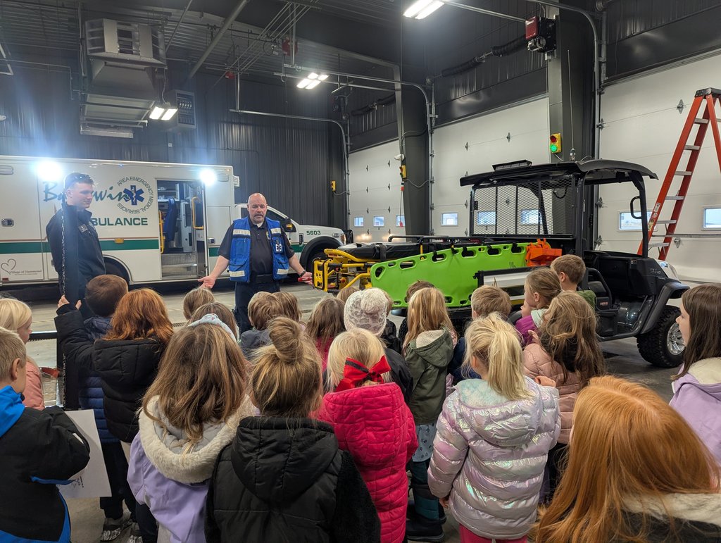EMS staff discussing ambulances with students.