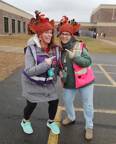 Ms. Kron and Ms. Earley outside with turkey hats.