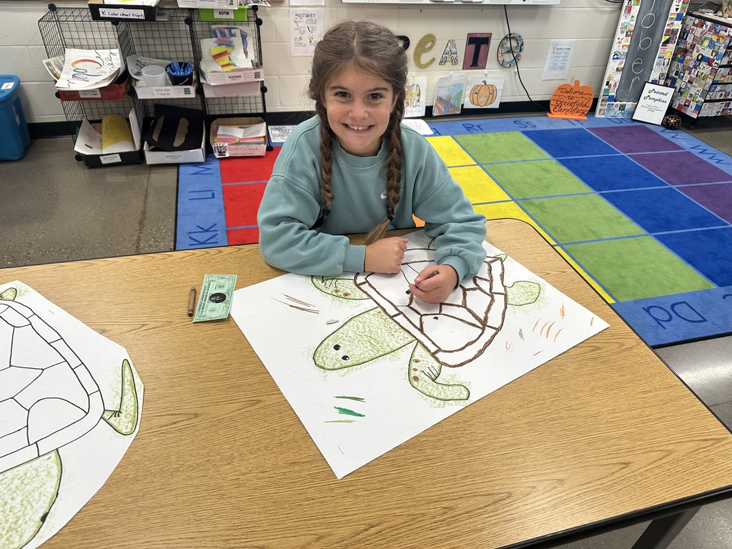 Student smiling while working on the project.