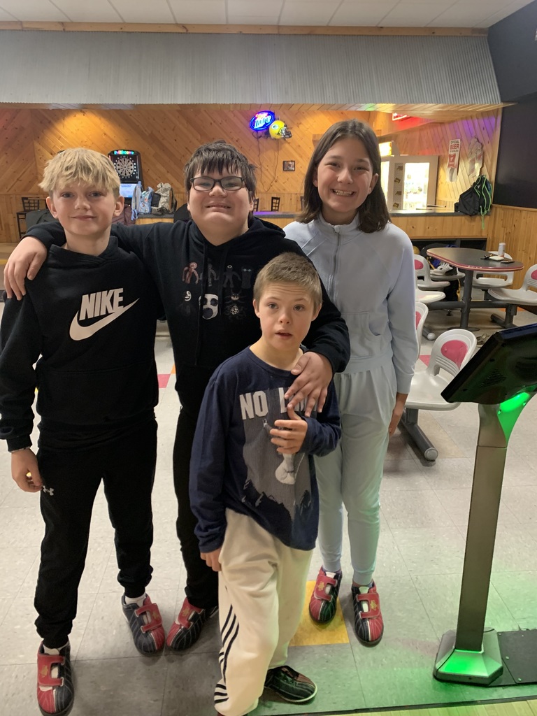 Students smiling at bowling alley.