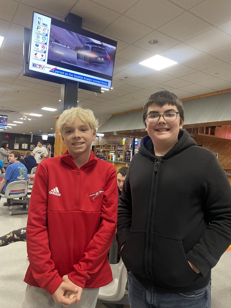 Two students smiling.