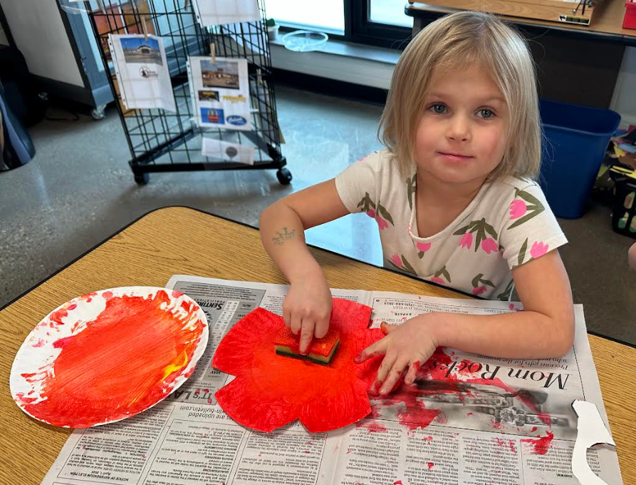 Student painting with a sponge.