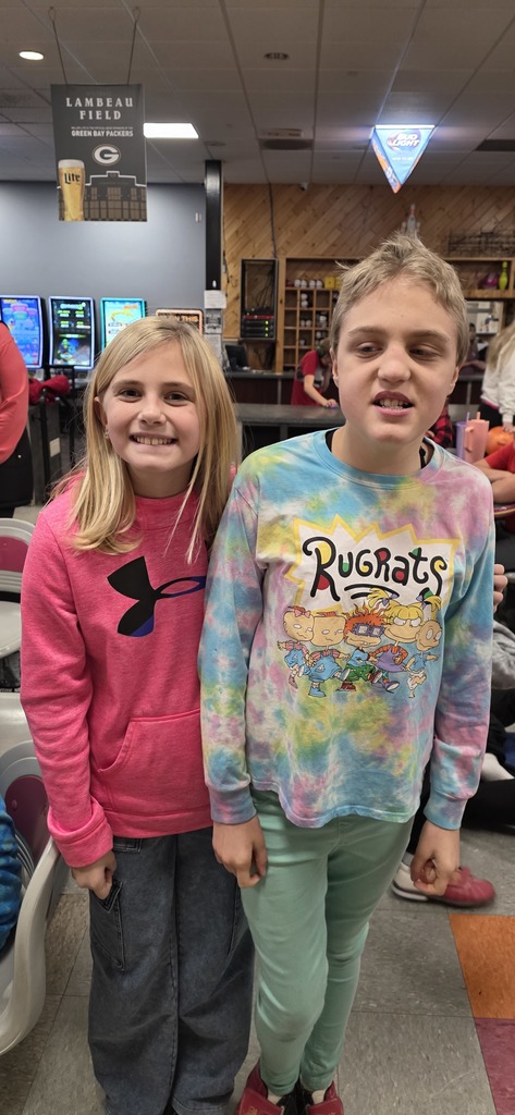 Two girls smiling and posing for a picture.