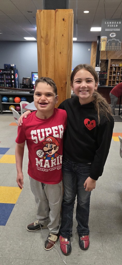 Two students smiling.