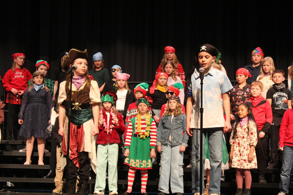 Students speaking on stage.