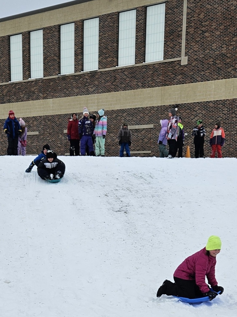 Students sledding on the hill.