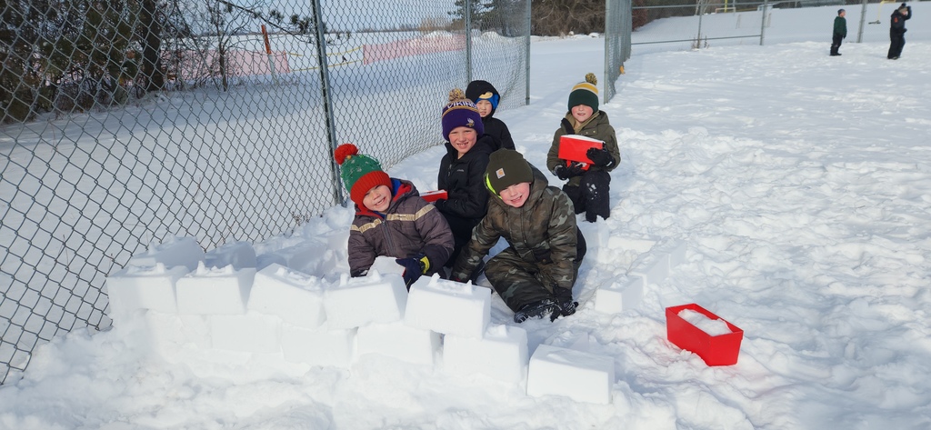 Students building a snow fort.