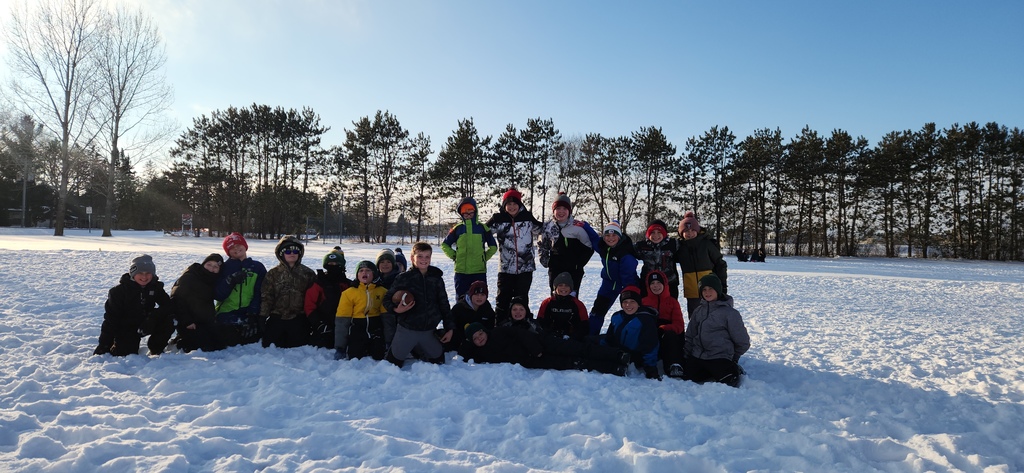 Group of students posing with a football.