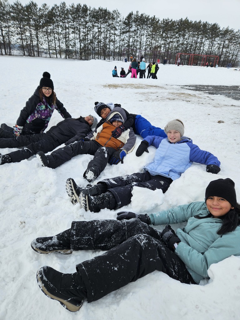 Students relaxing in the snow.