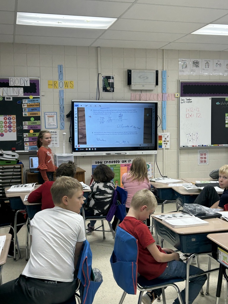 Students at SmartBoard for a math lesson.