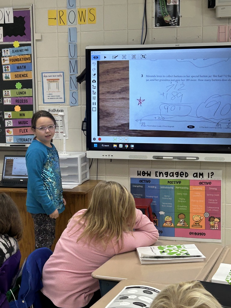 3rd grader presenting at the SmartBoard.