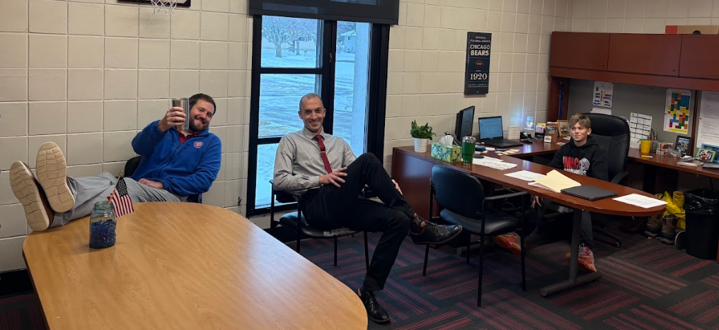 Principal Wolski hard at work. The other principals sitting and enjoying coffee.