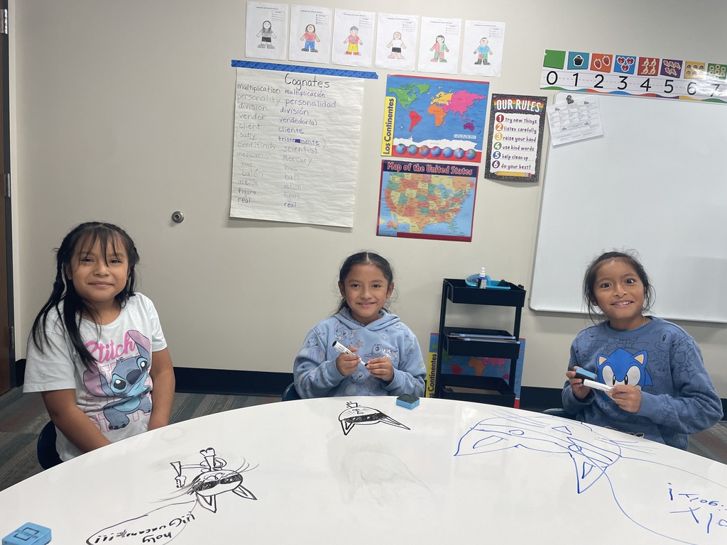 4th Grade Students and their drawings.