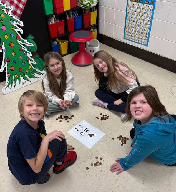 Students on the floor playing a math game.