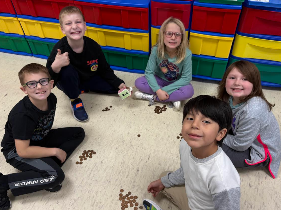 A group of students smiling and with a thumbs up!