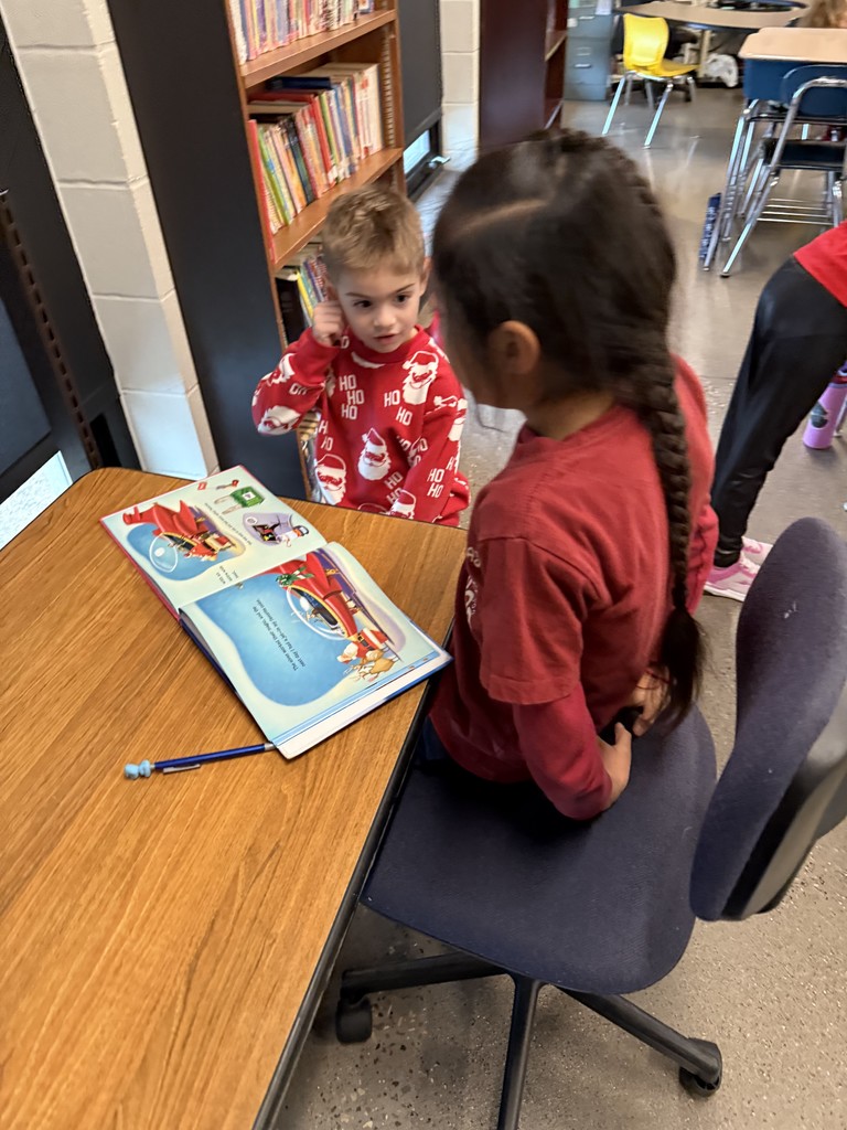 Two students reading at desk.