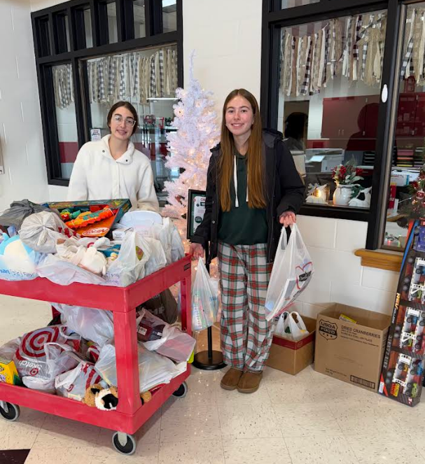 Two high school students with the toys they collected.