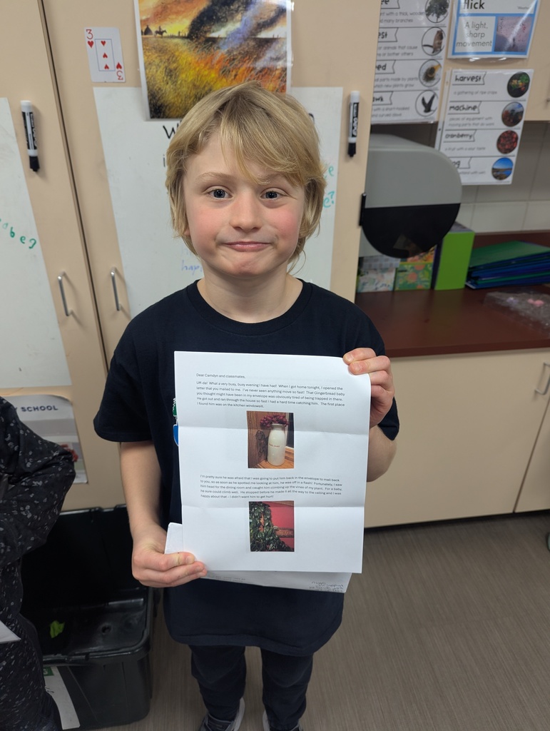 Student with their letter from their Gingerbread Baby