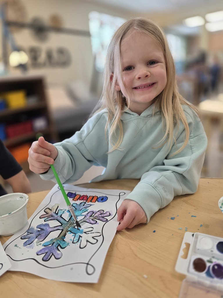 smiling student painting