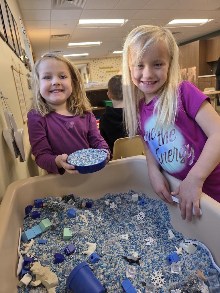 Studnets with a sensory table that was snow themed.