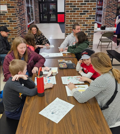 Students and parents completing worksheets.
