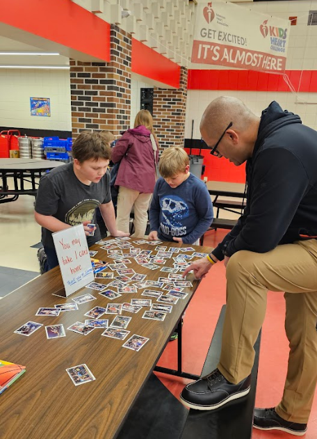 Students looking at basketball cards.