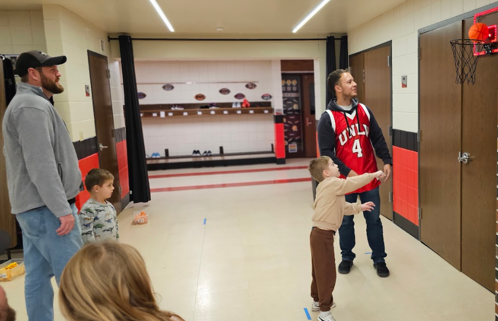 Student shooting a basketball while others watch