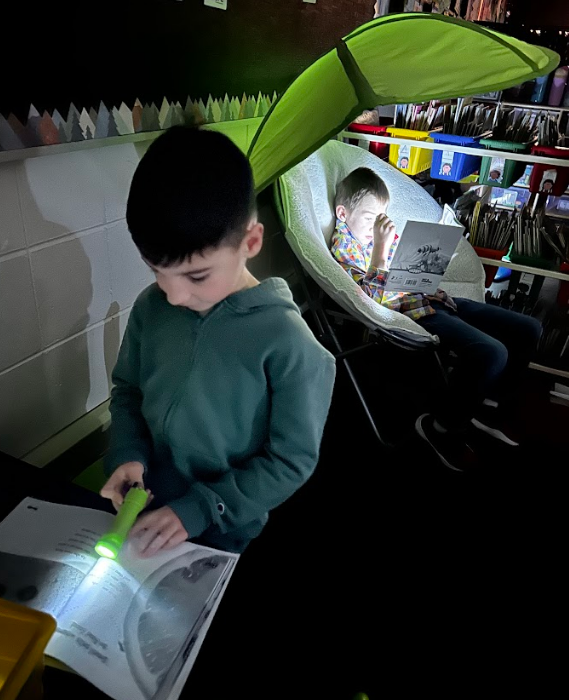 Students reading with their flashlights.