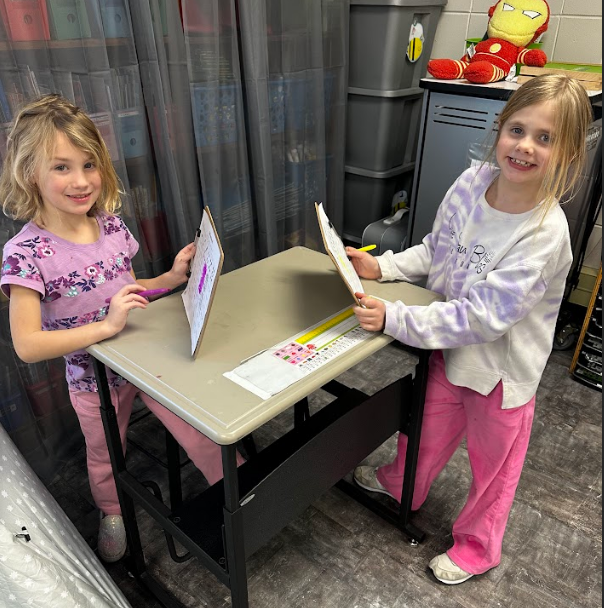 Two students playing battleship.