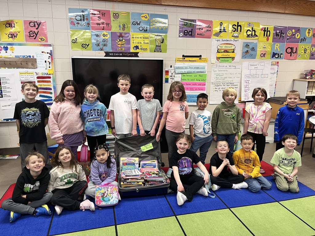 BW 1st Graders with a suitcase of books.