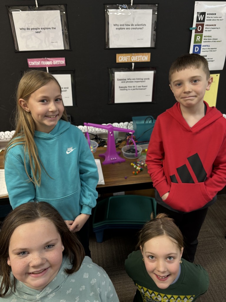 Four students measuring