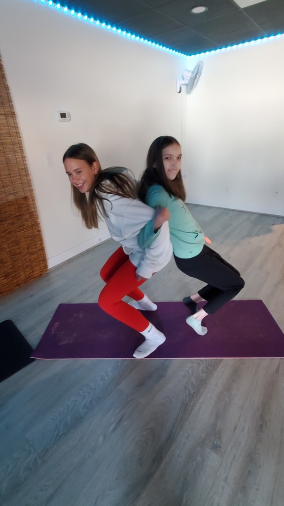 Two girls working on Yoga.